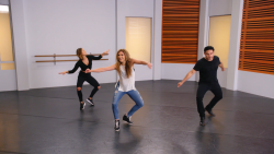 Three people in a dance studio dancing