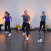 Three women doing a kickboxing class in a room with balloons
