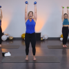 Three women doing narrow overhead presses in a room with balloons
