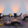 Three women doing core work with dumbbells