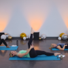 Women doing an ab workout on blue exercise mats