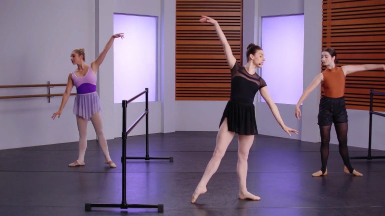Three women doing a beginner ballet barre class