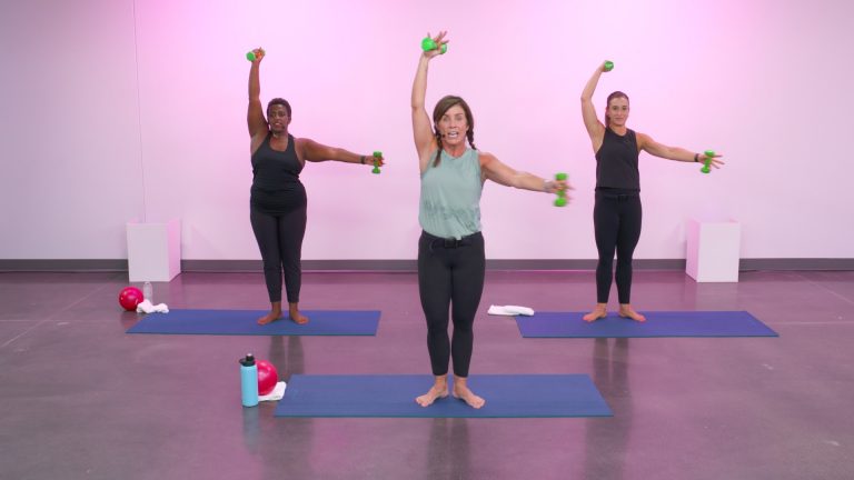 Three women doing barre workouts with weights