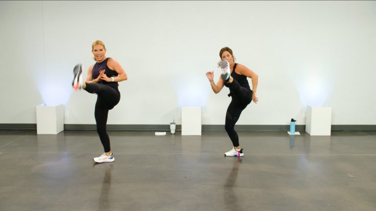 Two women kicking in a kickboxing workout
