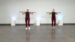 Two women with weighted bars working out