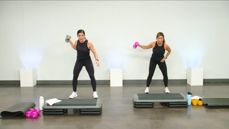 Two women working out with a dumbbell in one hand and a step