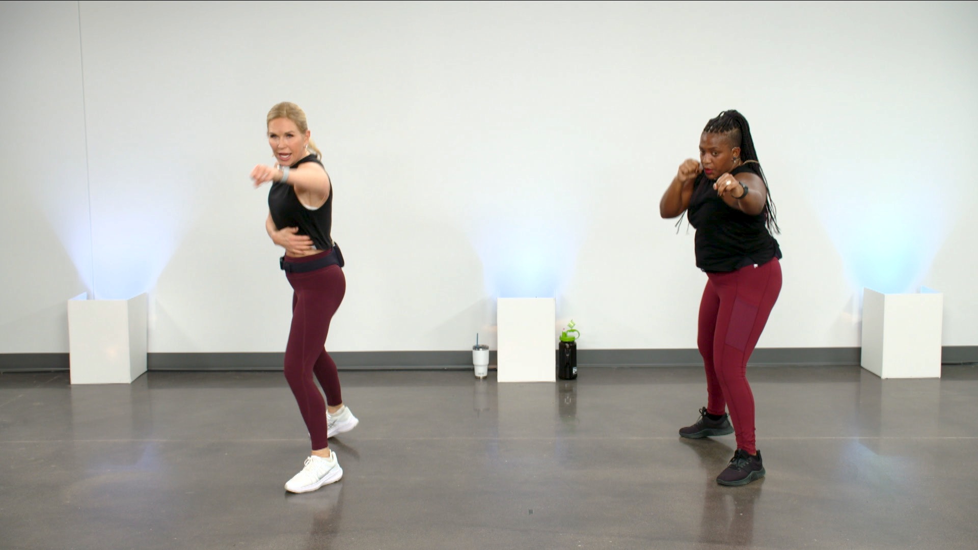 Two women doing a cardio kickboxing class