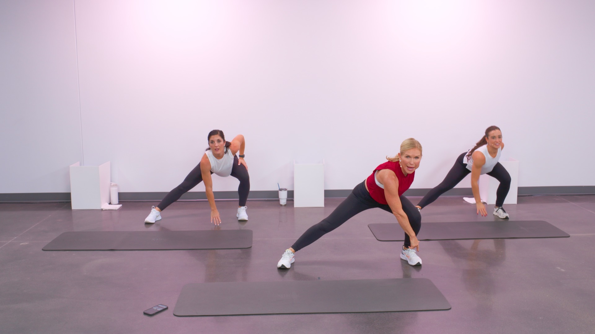 Three women working out on exercise mats