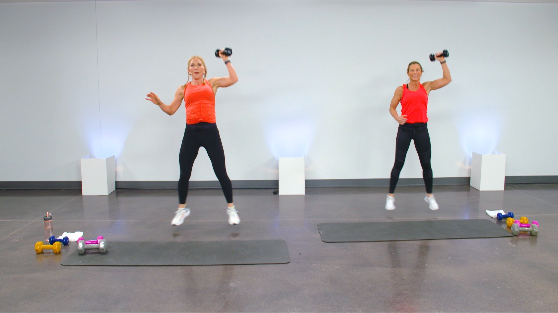 Two women working out with a dumbbell