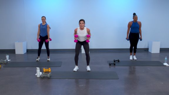 Three women doing an upper body workout with weights