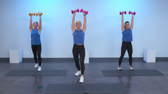 Three women doing an arm workout with dumbbells