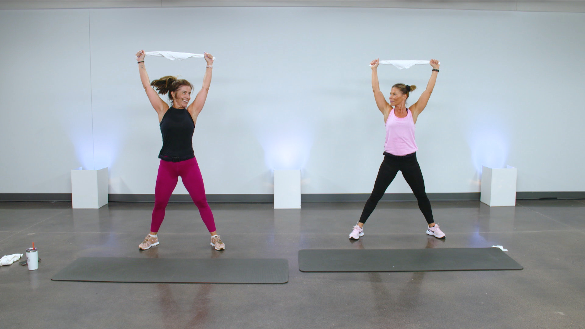 Two women working out with towels