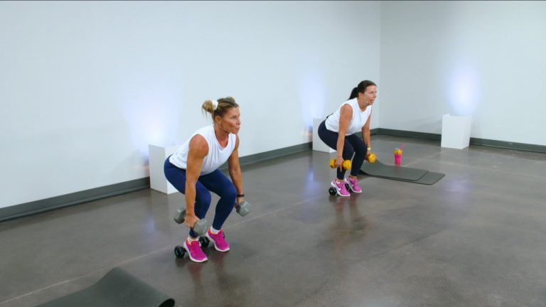 Two women doing narrow squats with dumbbells
