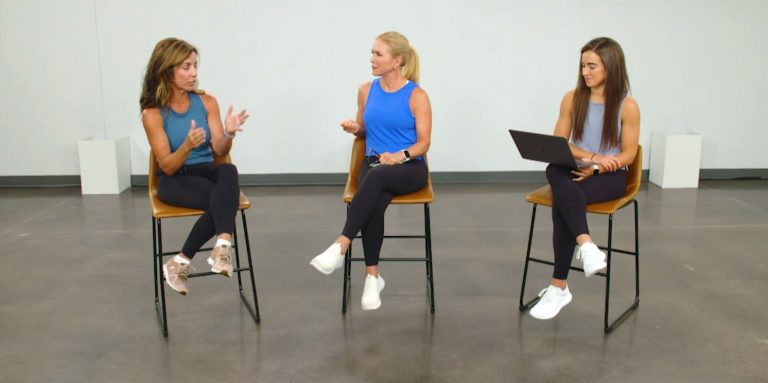 Three women sitting on tall chairs talking