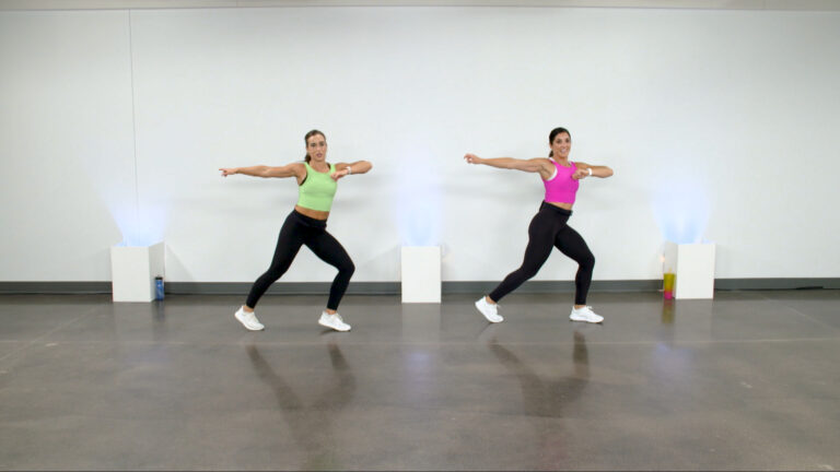 Two women in bright colored tank tops doing a dance cardio class