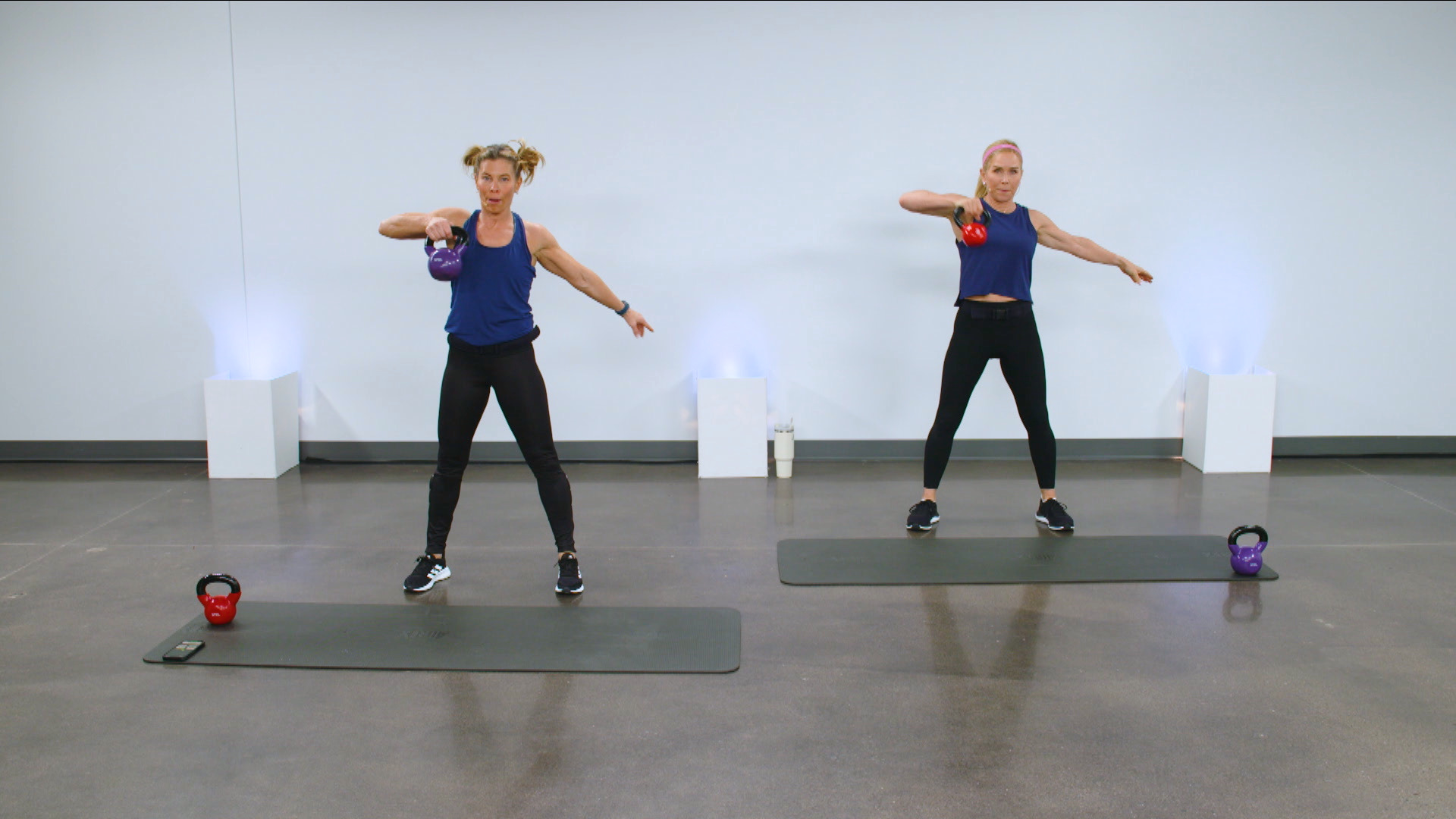 Two women working out with kettlebells