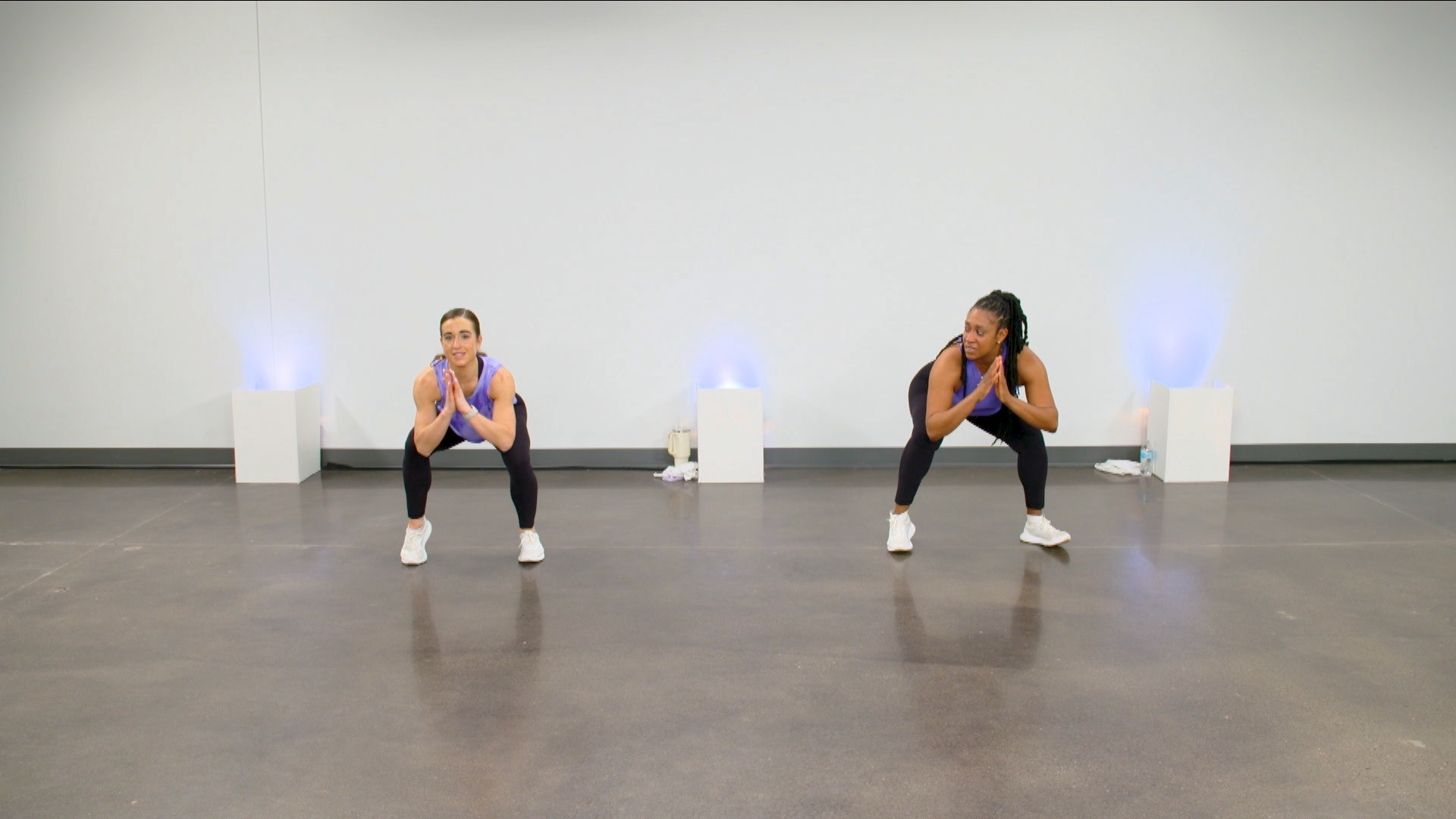Two women holding squats