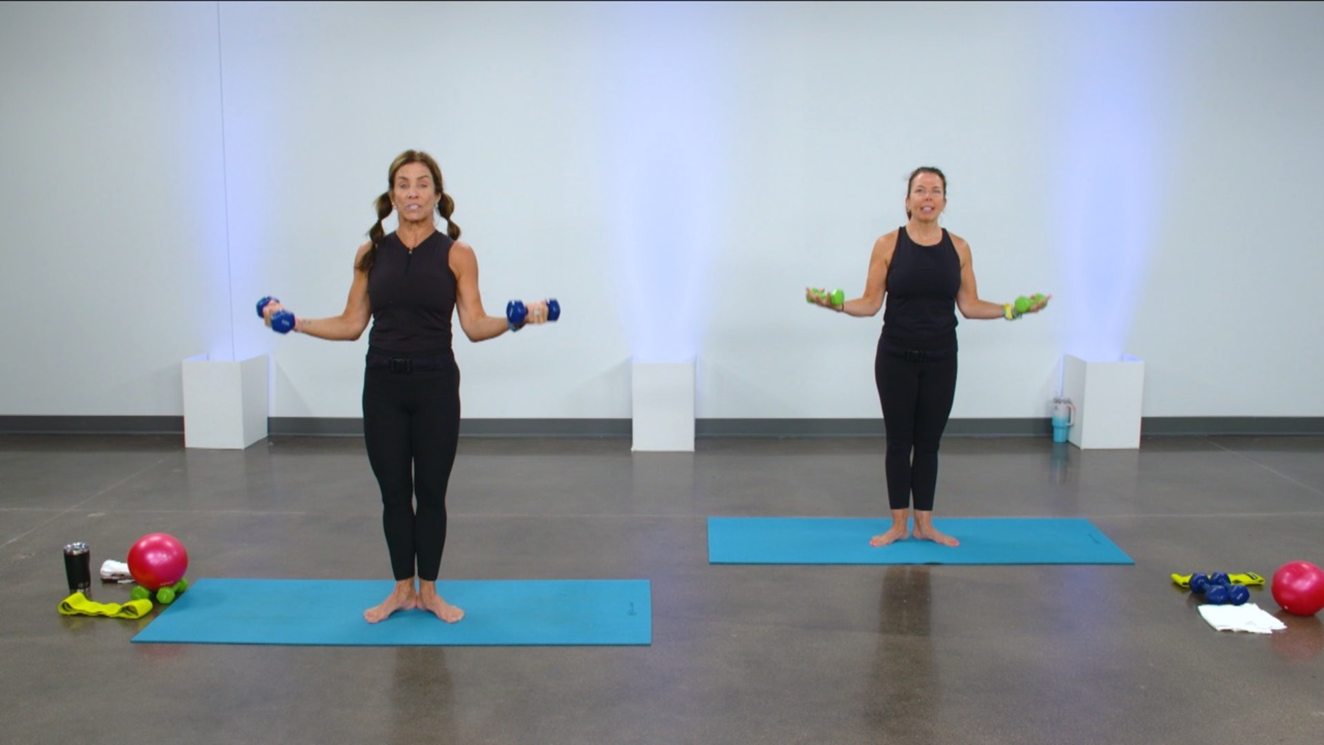 Two women doing barre with lite weights