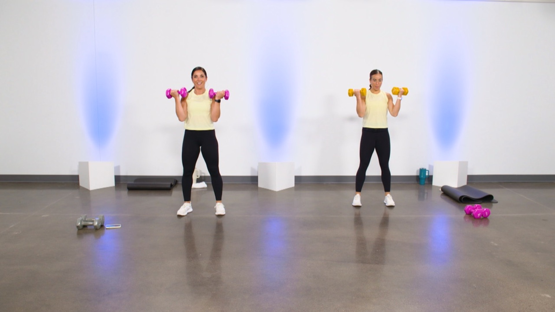 Two women doing bicep dumbbell curls