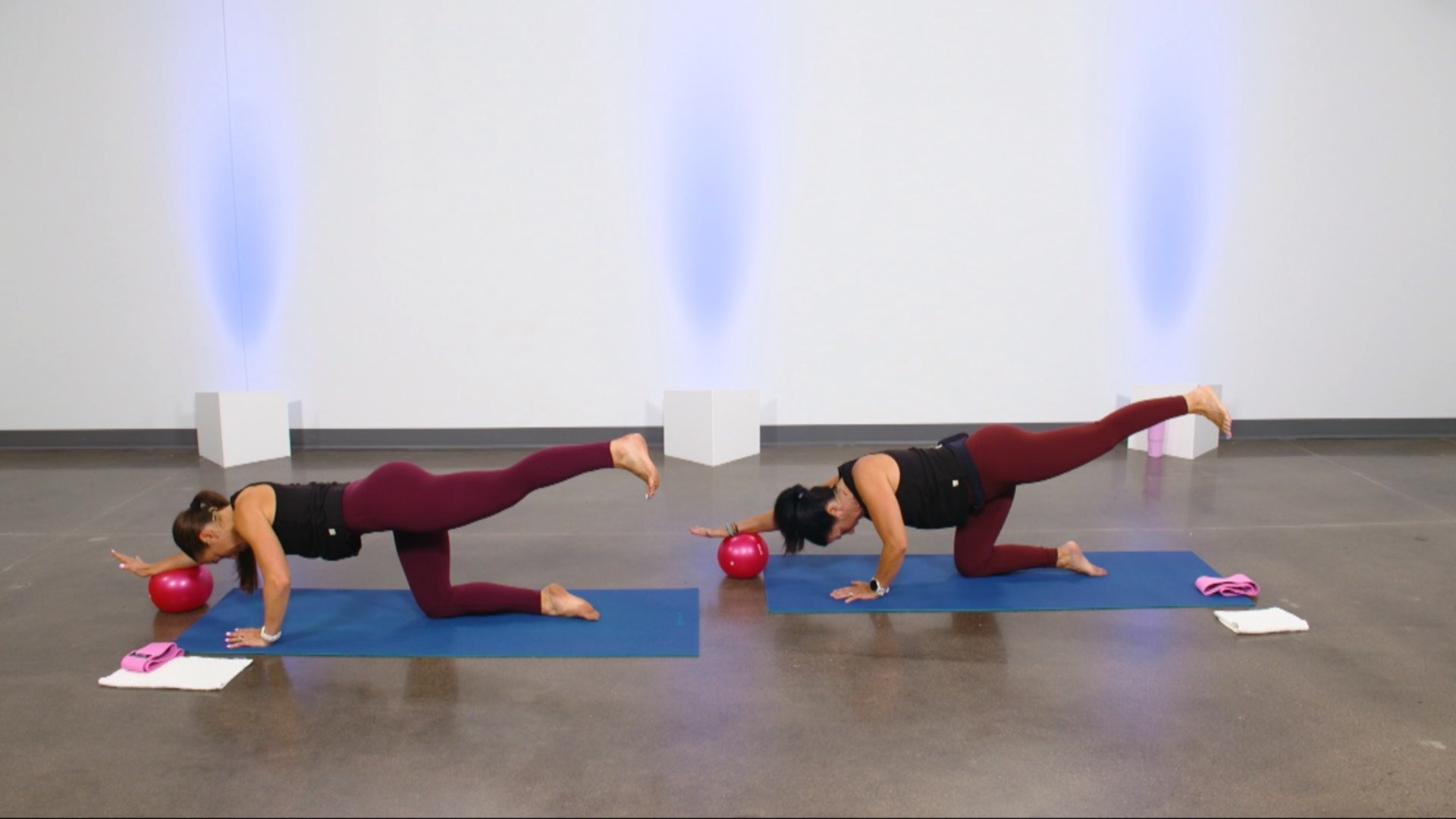 Two women working out with a ball