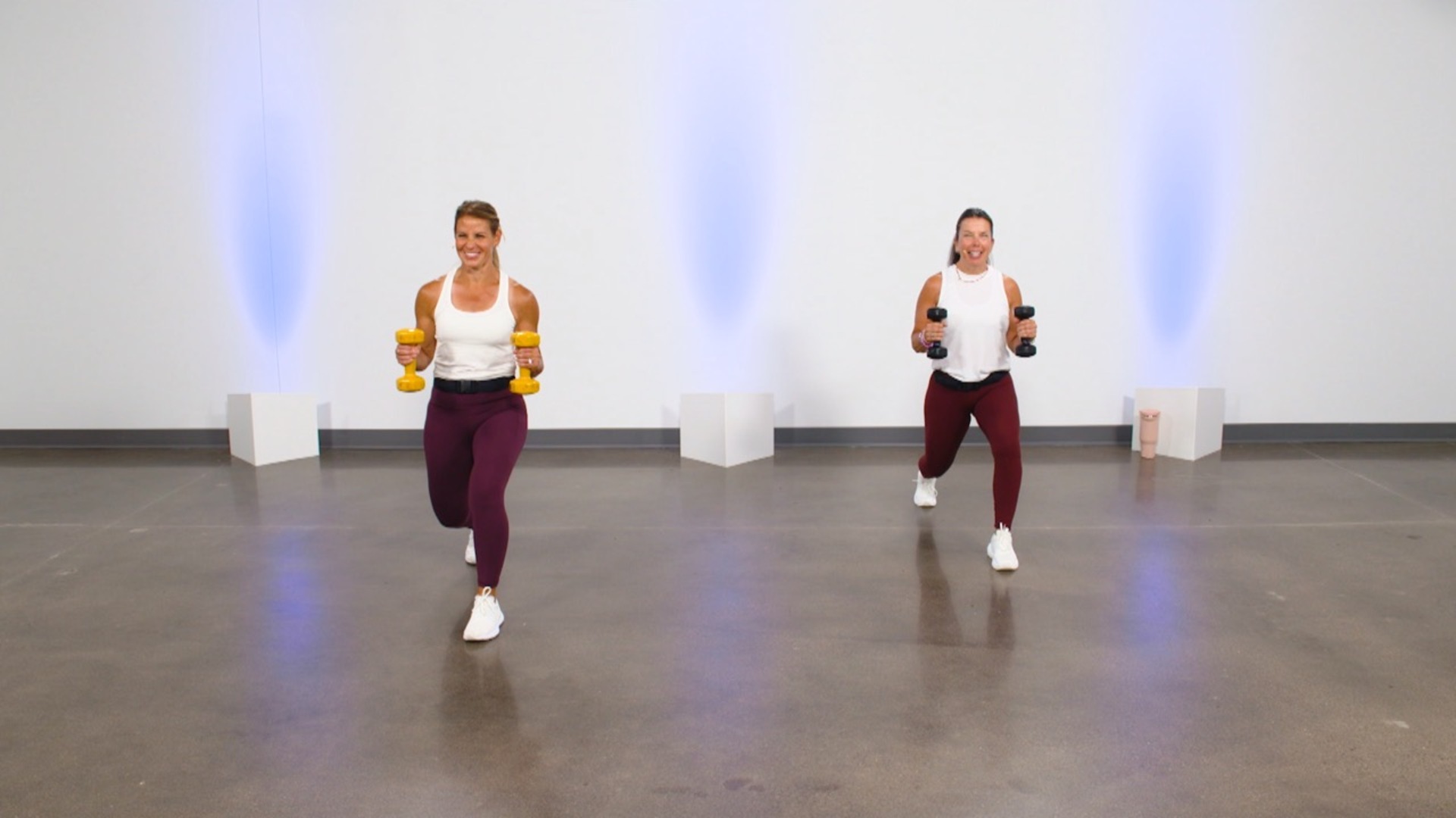 Two women working out with dumbbells