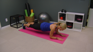 Woman holding a plank on a pink exercise mat