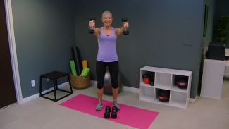 Women in a purple tank top working out with dumbbells