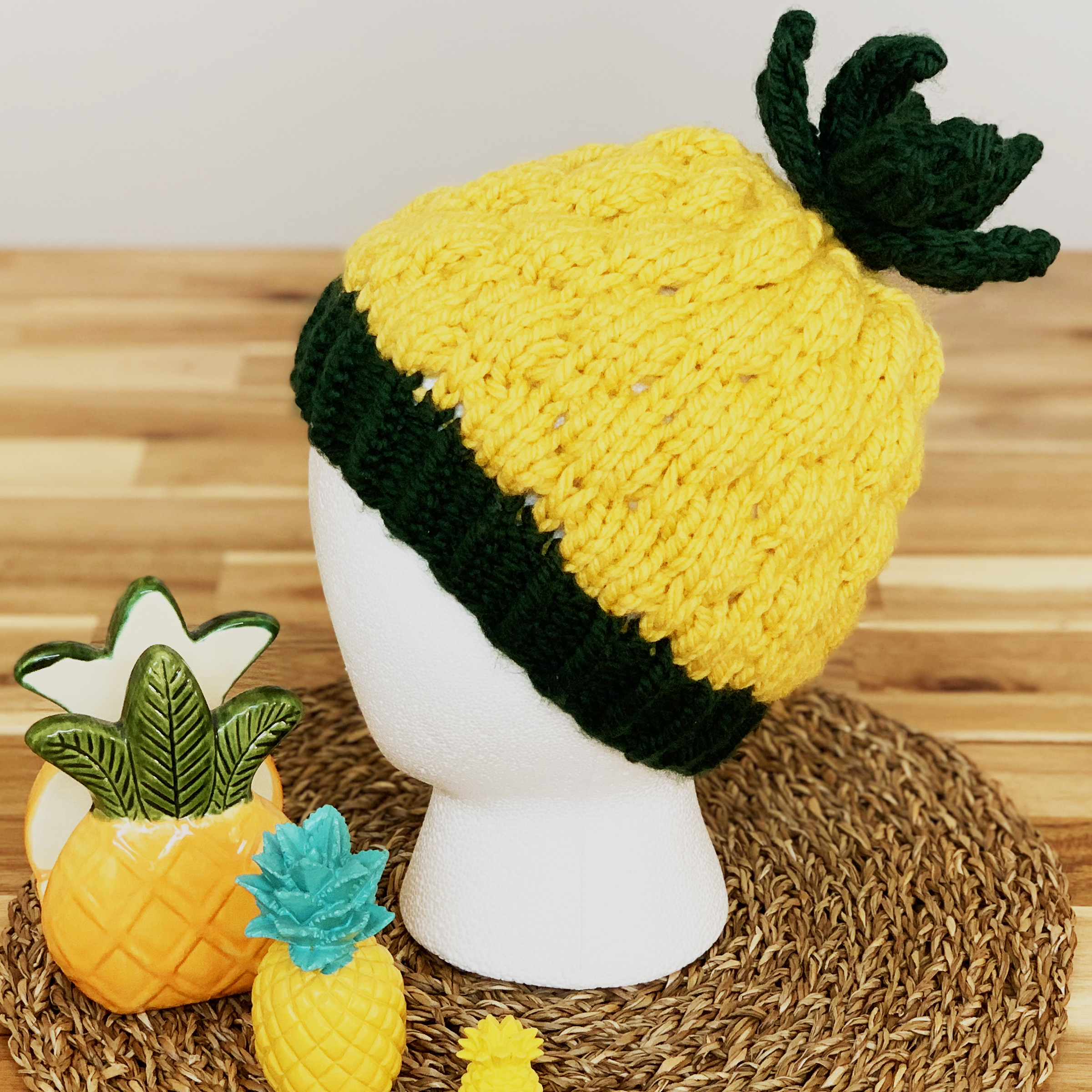 a yellow and black hat that is meant to resemble a pineapple on display head