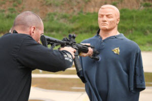 Demonstration of rifle striking a dummies chest