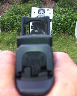 Handgun with the red dot threat focus 200