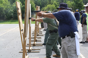 Image of students shooting from behind cover in line dance formation