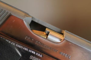Image of a gun with a colt malfunction