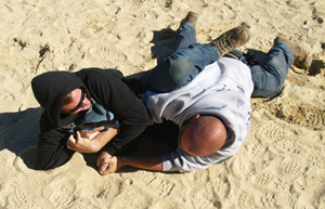 Demonstration of two men on the ground defending themselves