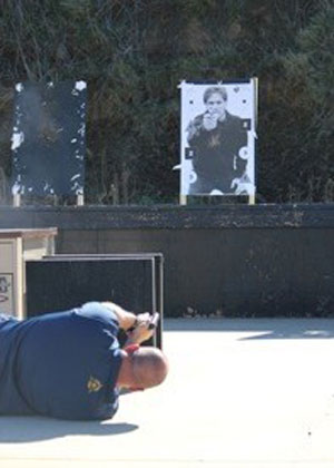 Man practicing shooting with laser gun at a target