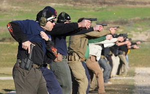 A group of people practicing with their firearms