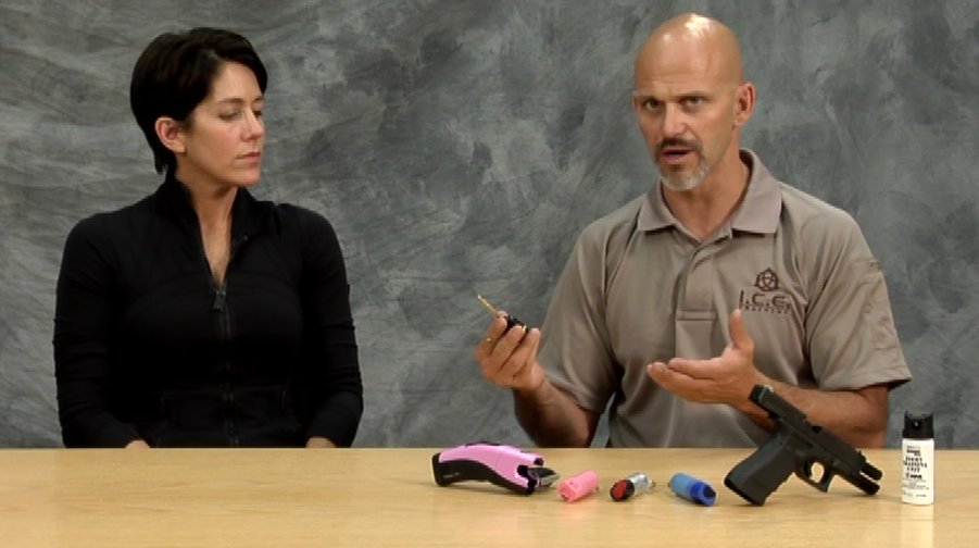 Man and woman at a table with self-defense items