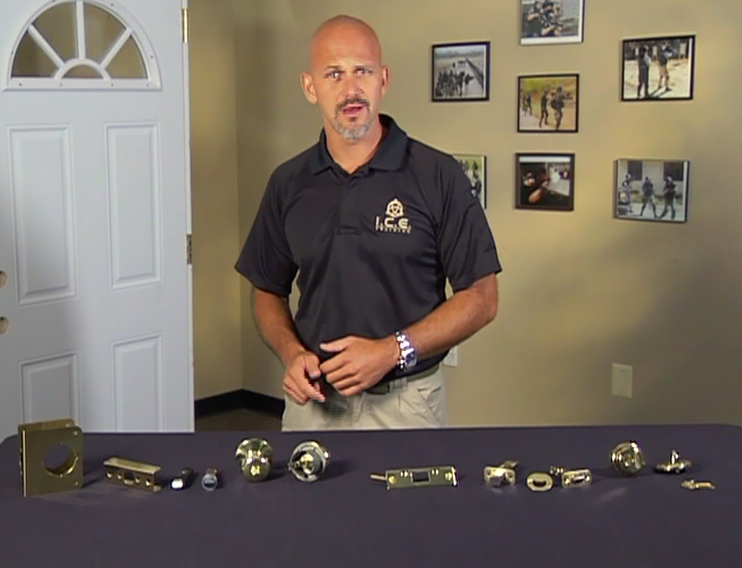 Man with door handles and locks on a table