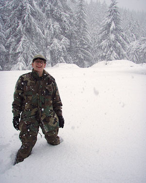 man shooting in snow