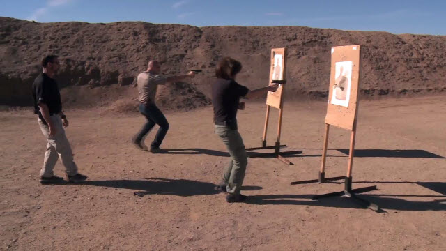 Men aiming at outdoor targets