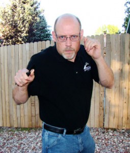 Step 1. Author demonstrates a high-line comma-cut thrust. It begins by chambering near the right shoulder.