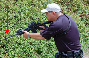 Modified Low Ready Position: The degree the muzzle is depressed is dependent on the distance from the threat. Here the threat is close, so the muzzle is lower, providing a good visual of the threat’s hands.