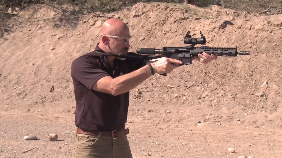 Man aiming an AR-15 pistol