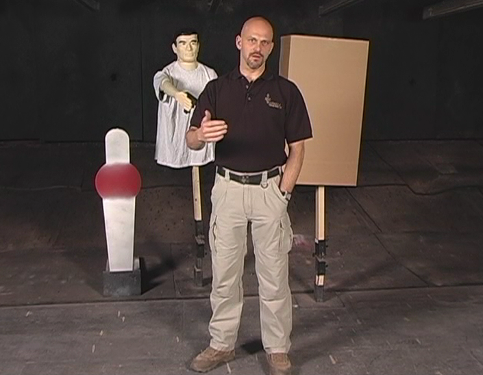 Man standing in front of self-defense materials