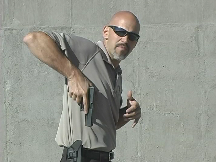 Man drawing a gun from a holster