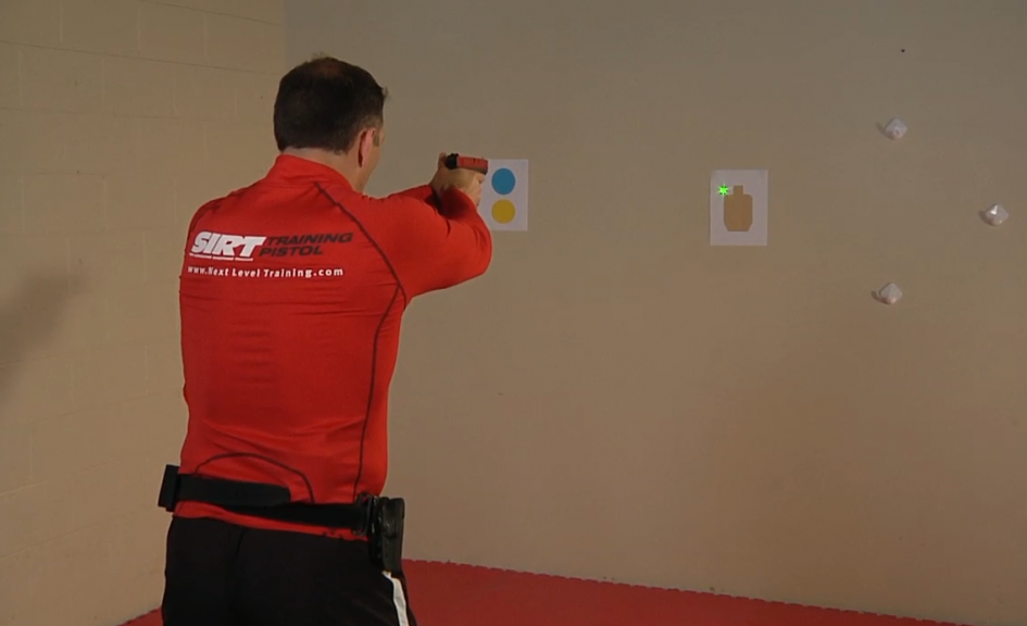Man aiming a laser from a gun at a target
