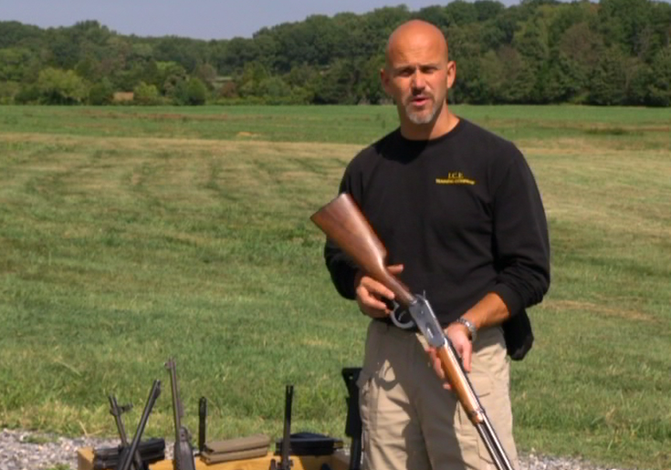 Man standing outside with a long gun