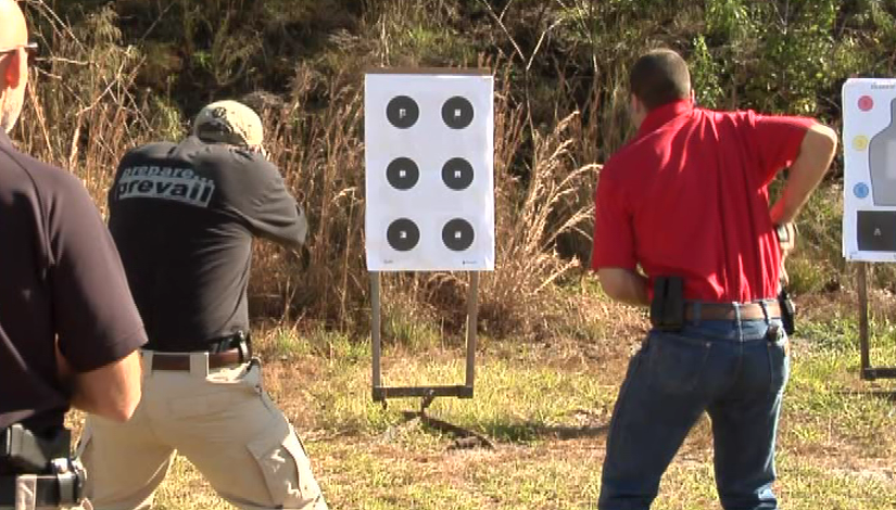 Man practicing shooting at a target