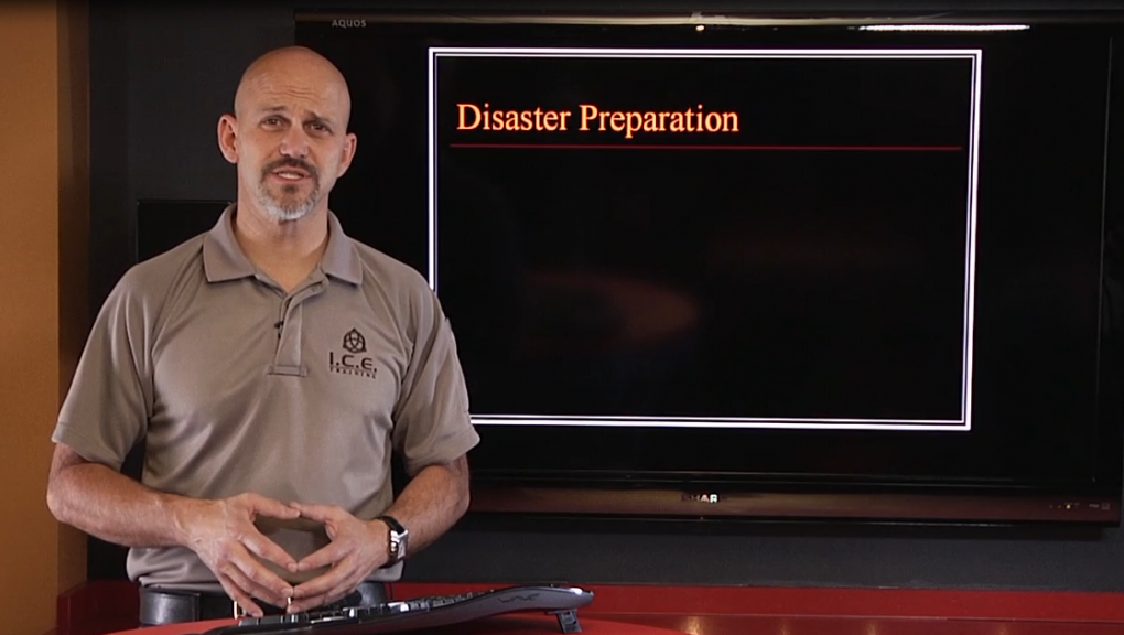 Man talking with disaster preparation on a screen behind him