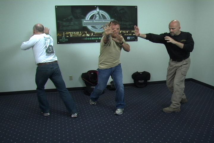 Three men practicing personal defense