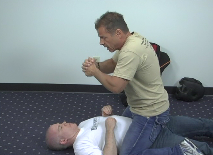 Man straddling the stomach of another man in self-defense
